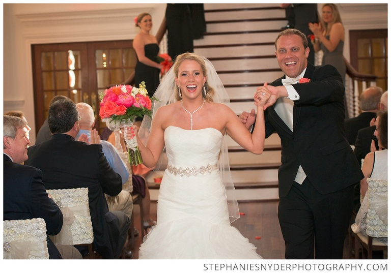 Bride and Groom celebrate just getting married on the staircase of the Ryan Nicholas Inn in Greenville, SC. Photographed by Stephanie Snyder Photography, a Greenville, SC wedding photographer.